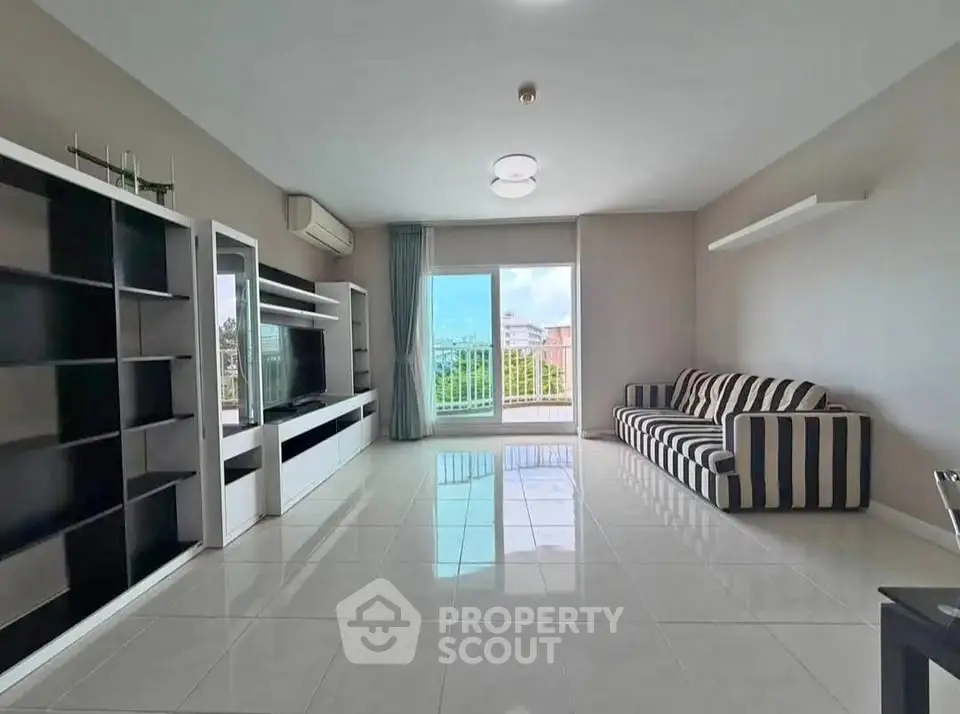 Spacious modern living room with large window and stylish furniture