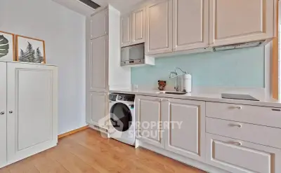 Modern kitchen with sleek cabinetry and built-in appliances