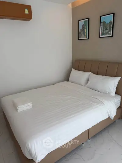 Modern bedroom with cozy bed and stylish decor in a contemporary apartment.