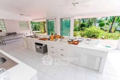Spacious open-layout kitchen with garden view and modern appliances