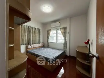 Cozy bedroom with modern furnishings and ample natural light