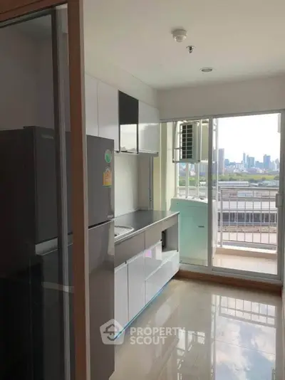 Modern kitchen with balcony view in high-rise apartment