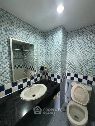 Modern bathroom with mosaic tiles and sleek fixtures