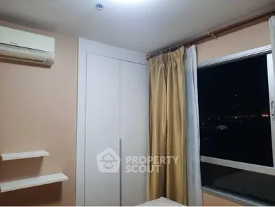 Cozy bedroom with air conditioning and night city view from window