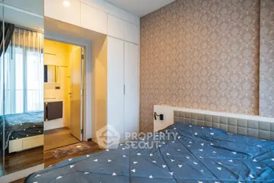 Modern bedroom with stylish wallpaper and built-in wardrobe