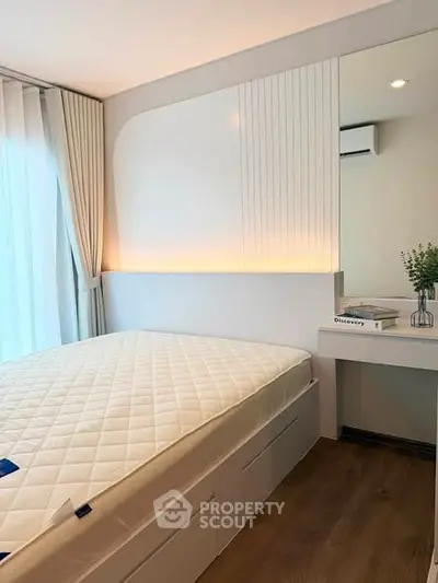 Modern bedroom with elegant design, featuring a cozy bed, stylish lighting, and a sleek vanity area.