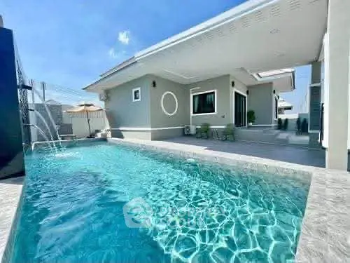 Luxurious modern home with private swimming pool and spacious patio area.