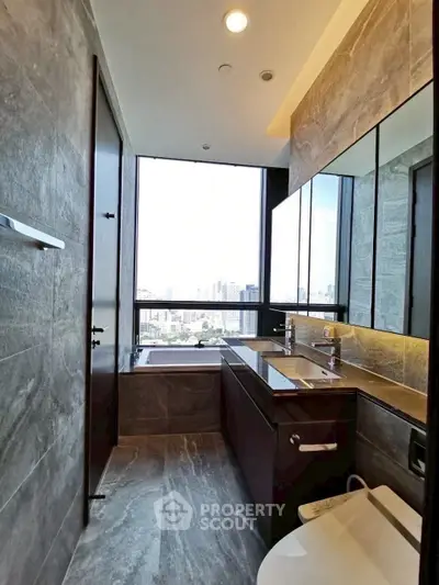 Luxurious bathroom with city view, featuring modern fixtures and elegant stone finishes.
