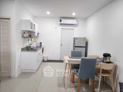 Modern kitchen and dining area with sleek appliances and stylish furniture