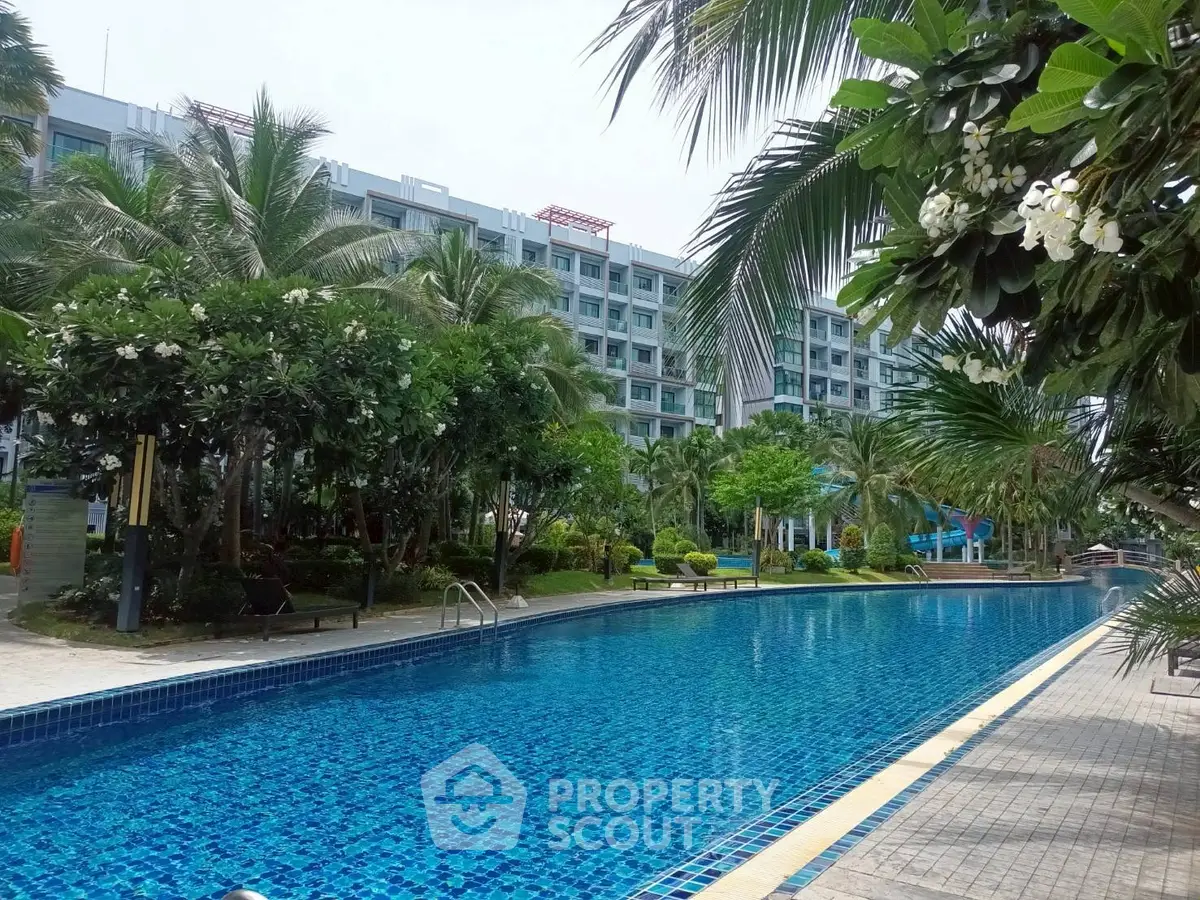 Luxurious residential complex with stunning pool and lush greenery
