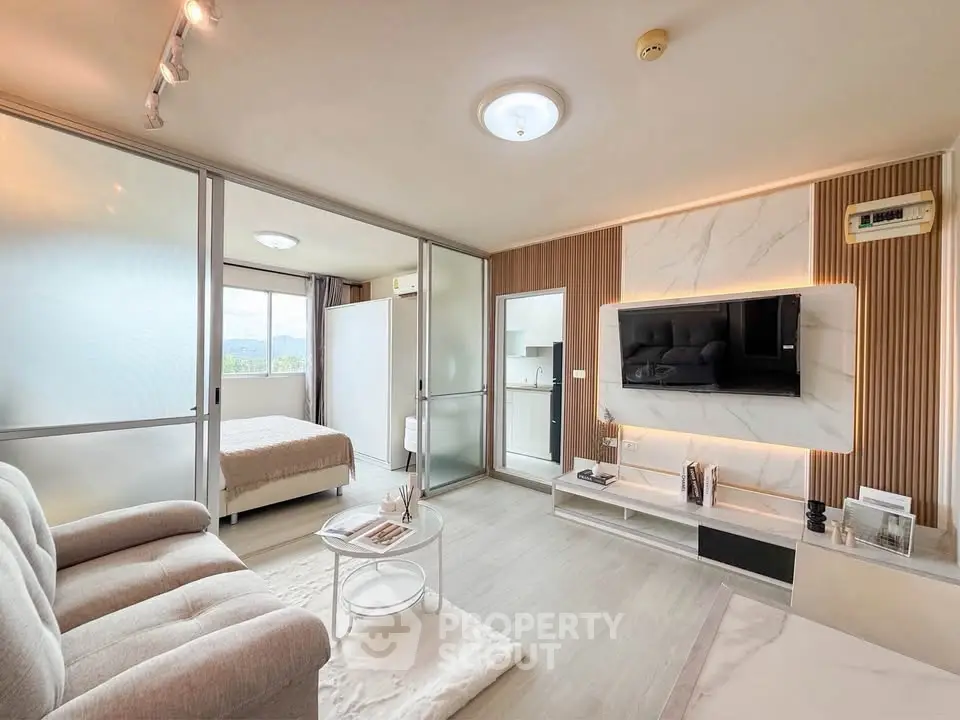 Modern open-plan living room with stylish decor and natural light