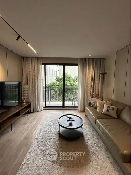 Modern living room with large window and stylish furniture