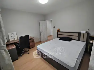 Spacious bedroom with modern furniture and cozy ambiance, perfect for relaxation.