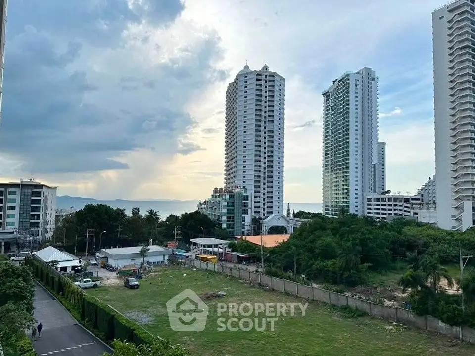 Stunning cityscape view with modern high-rise buildings and lush greenery.
