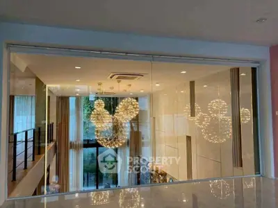 Luxurious modern living room with stunning chandelier and floor-to-ceiling windows