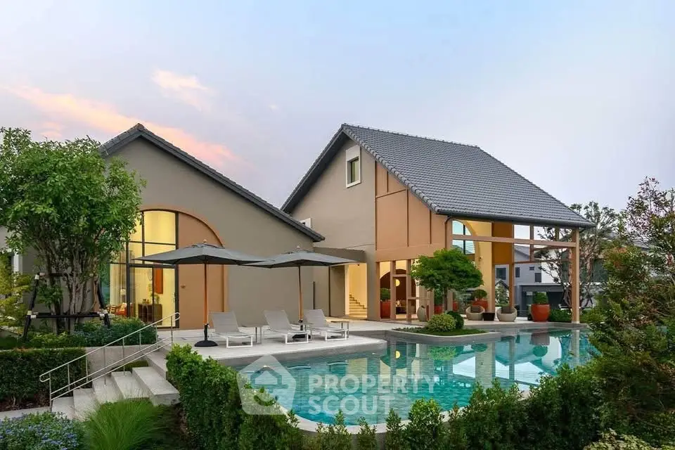 Luxurious modern home with stunning pool and lush garden, perfect for serene living.