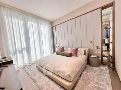 Luxurious bedroom with modern design, plush bedding, and floor-to-ceiling windows for natural light.