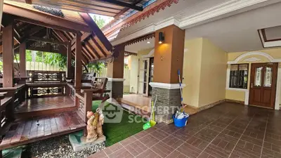 Charming traditional-style home with wooden gazebo and spacious covered patio.