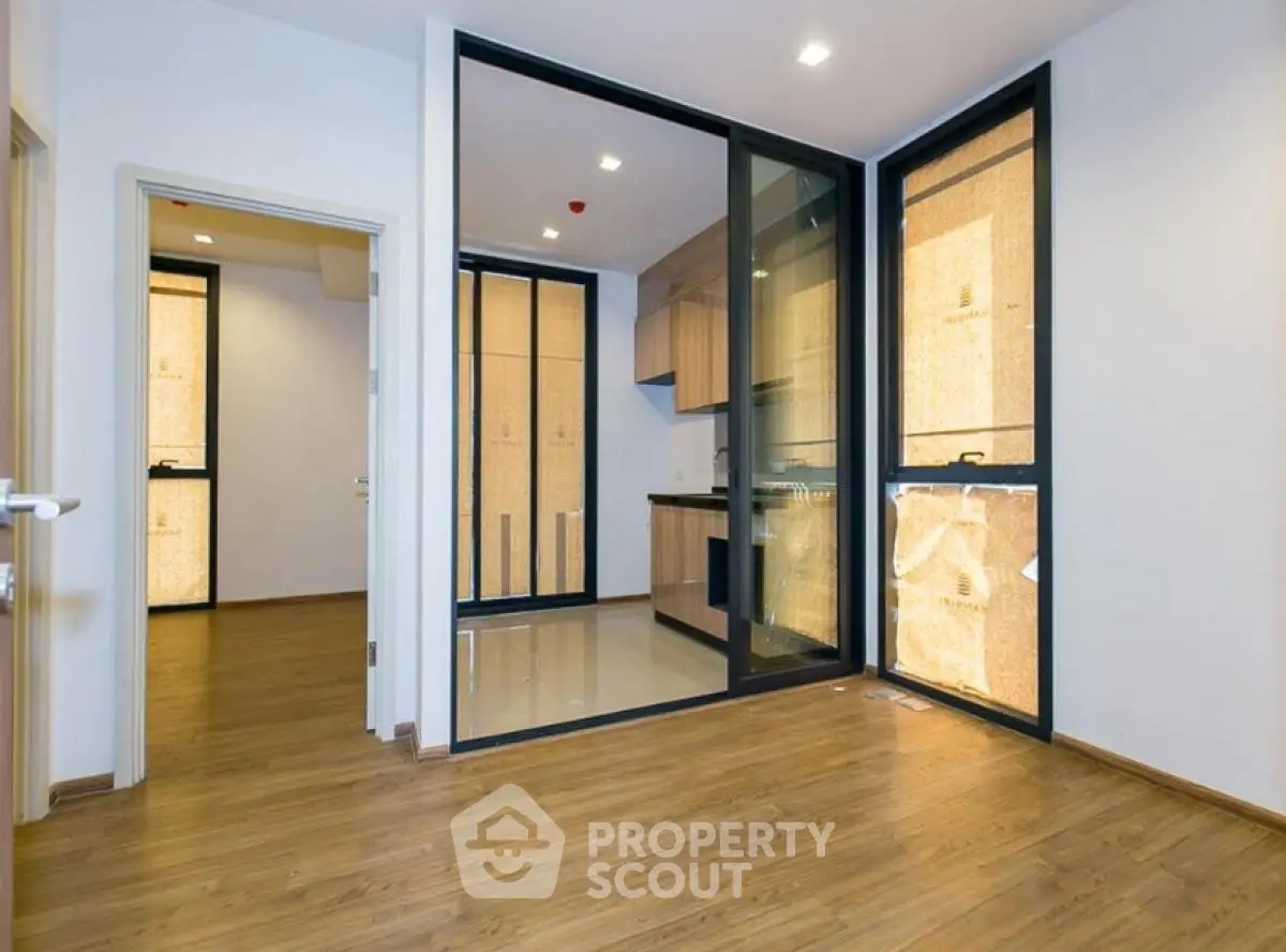 Modern apartment interior with open kitchen and wooden flooring