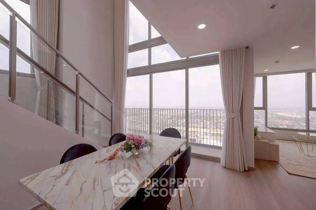 Luxurious high-rise apartment with stunning city view and elegant dining area.