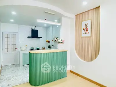 Charming kitchen with modern design and unique green island, perfect for culinary enthusiasts.