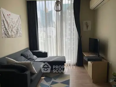 Modern living room with city view, stylish sofa, and natural light.