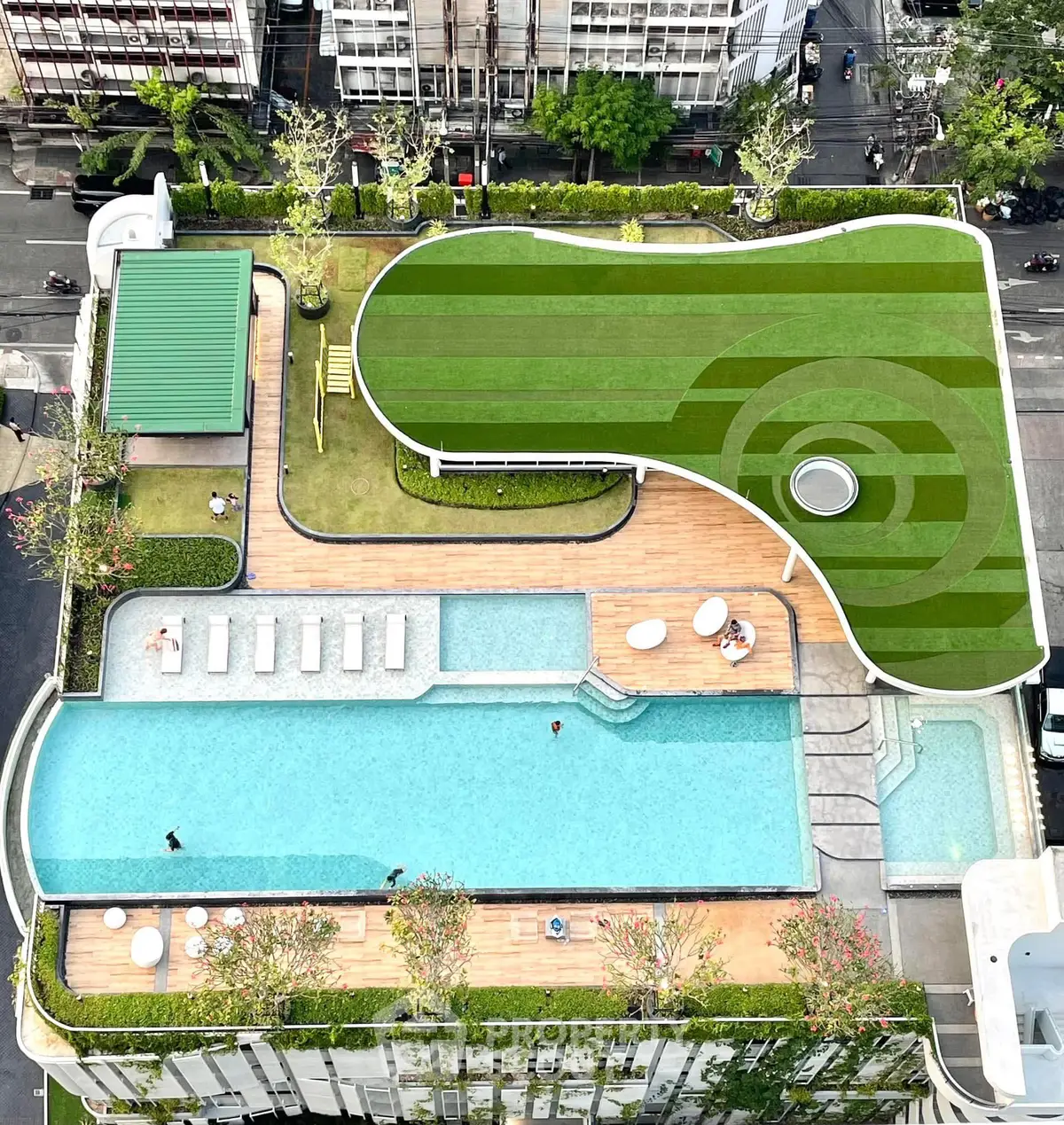 Stunning rooftop pool and garden area with modern design and city views, perfect for relaxation and leisure.