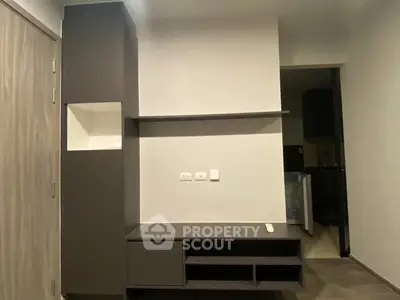 Modern minimalist living room with sleek storage and open shelving