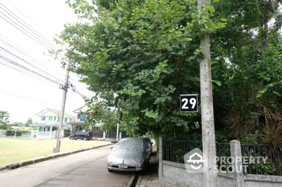 Charming suburban street view with lush greenery and residential homes, perfect for family living.