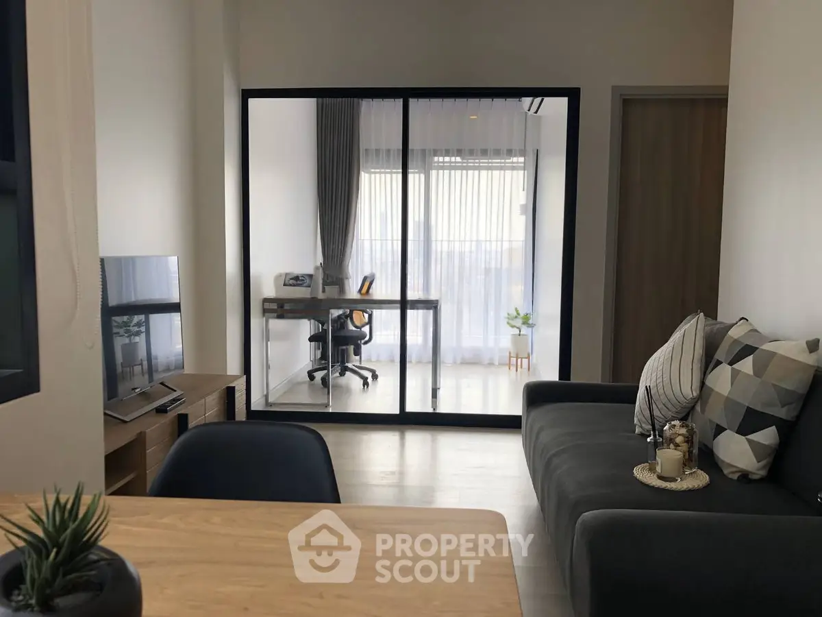 Modern living room with glass partitioned study area and stylish decor