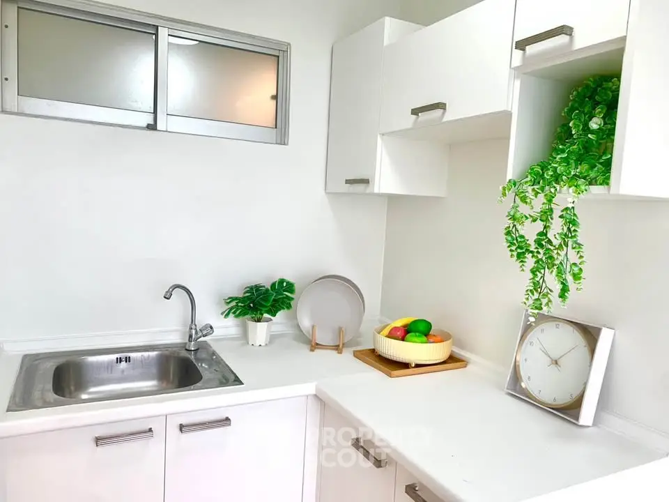 Modern white kitchen with sleek cabinets and stylish decor