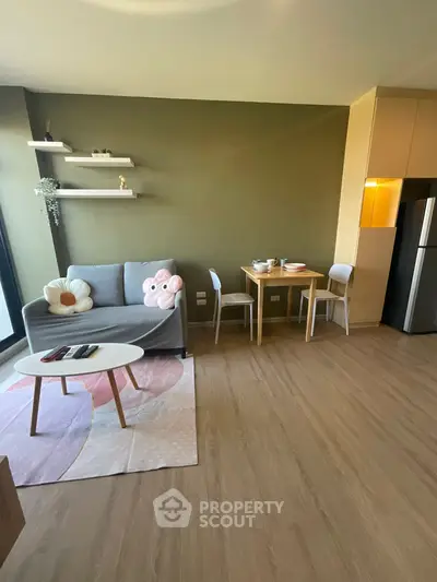 Modern living room with cozy sofa and dining area in open layout apartment.