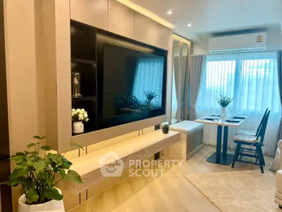 Modern living room with stylish decor and natural light, featuring a cozy dining area and sleek entertainment unit.