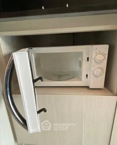 Modern kitchen with built-in microwave oven in sleek cabinetry