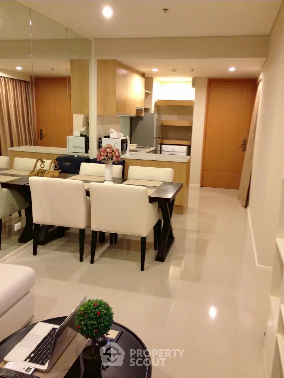 Modern open-plan living and dining area with sleek kitchen design