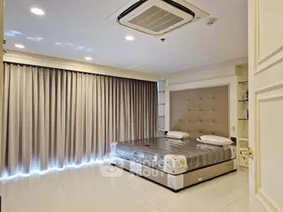 Luxurious bedroom with elegant decor and large windows in modern apartment