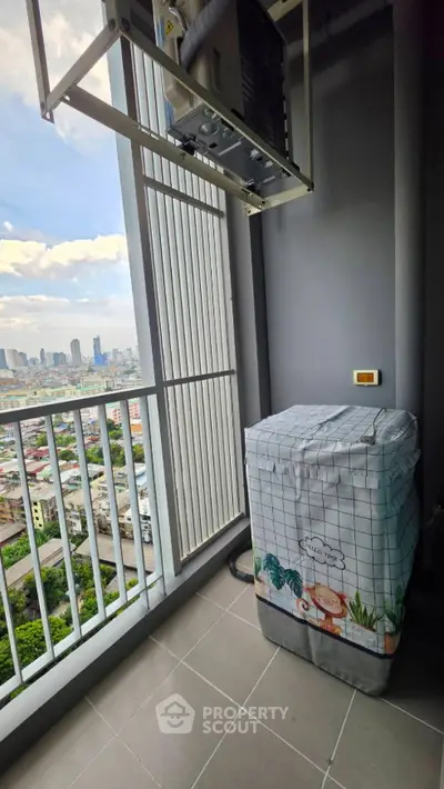 High-rise balcony with city view and covered washing machine
