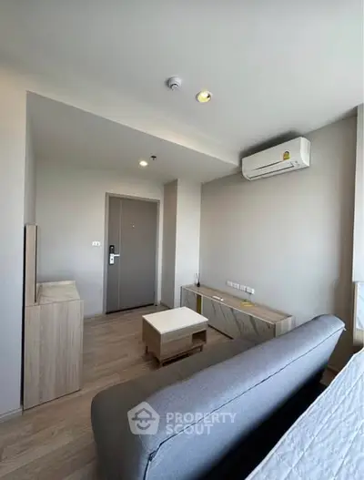 Modern living room with sleek furniture and air conditioning in a cozy apartment.