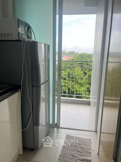 Modern kitchen with balcony view and stainless steel appliances
