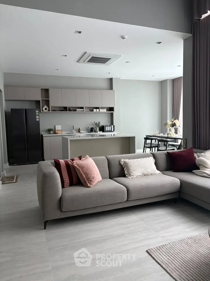 Spacious modern living room with open kitchen and stylish decor