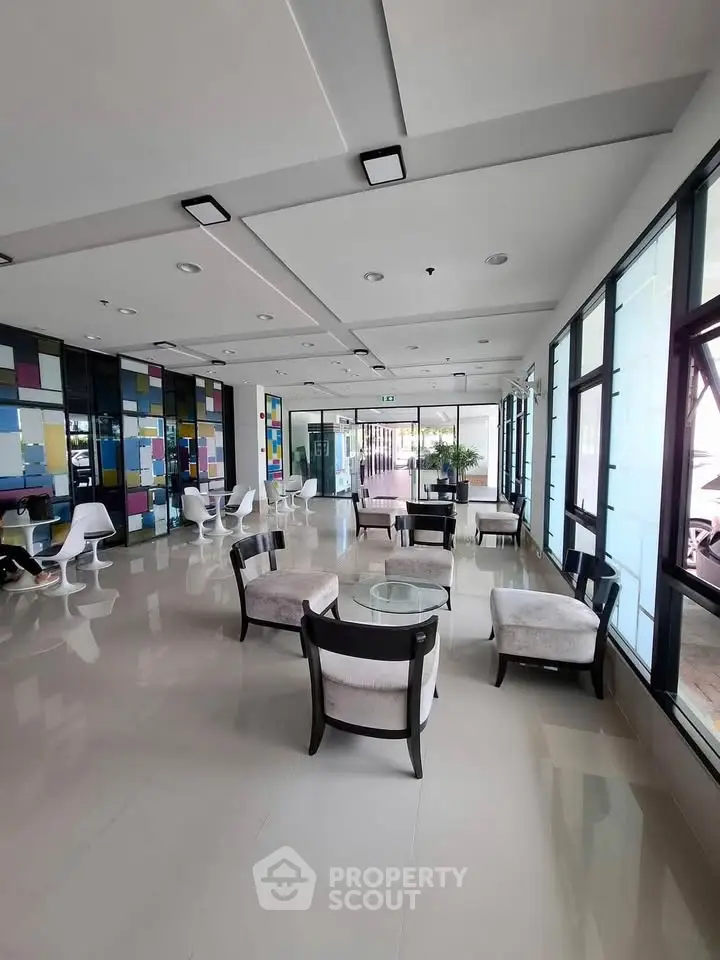 Modern lobby with stylish seating and colorful wall accents in a contemporary building.