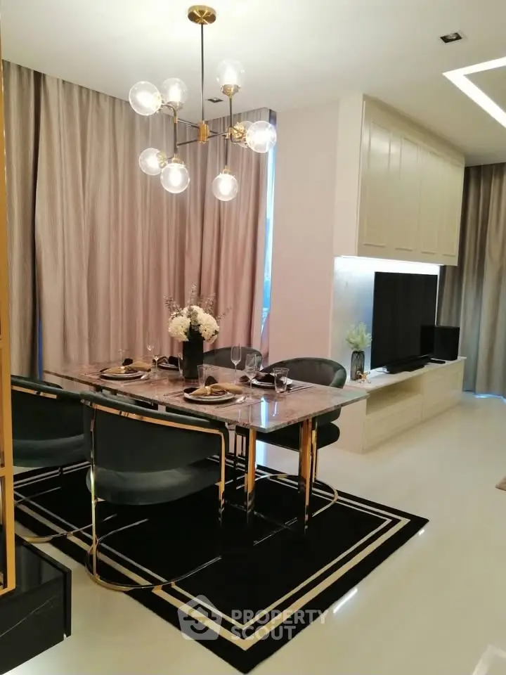 Elegant dining area with modern chandelier and stylish decor in a luxurious apartment.