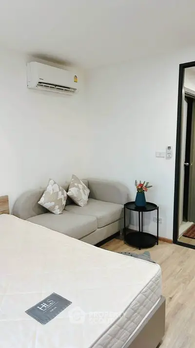 Cozy bedroom with modern decor and air conditioning in a stylish apartment.