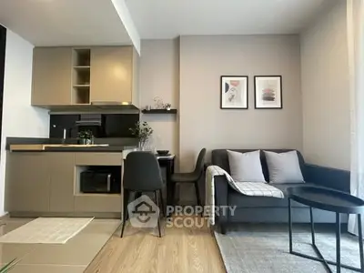 Modern open-plan living room with stylish kitchen and cozy seating area, perfect for urban living.