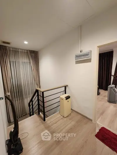 Modern interior hallway with wooden flooring and elegant curtains