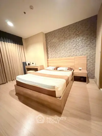 Modern bedroom with stylish wooden furniture and elegant wallpaper accent wall.