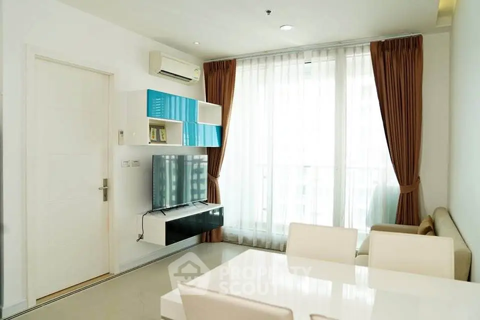 Modern living room with sleek furniture and large windows in a stylish apartment.