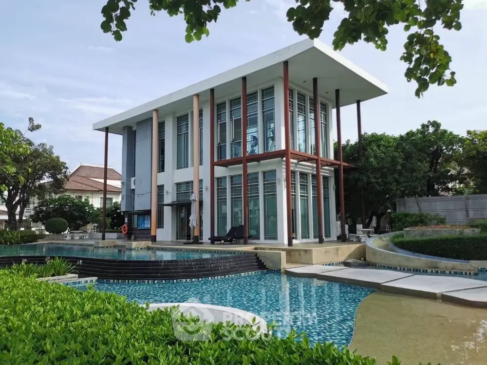 Stunning modern two-story house with pool and lush garden