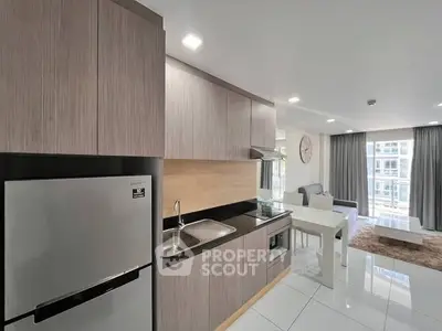 Modern kitchen with sleek cabinetry and open layout in a bright apartment.
