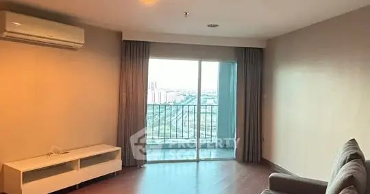 Spacious living room with balcony and city view in modern apartment
